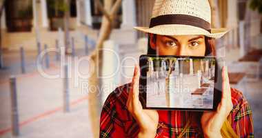 Composite image of portrait of woman hiding face with digital tablet