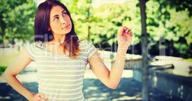 Composite image of thoughtful young woman standing