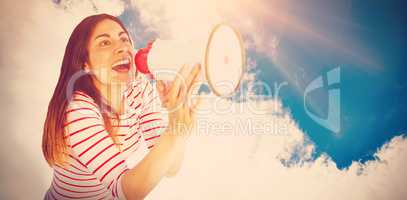 Composite image of young woman shouting with megaphone