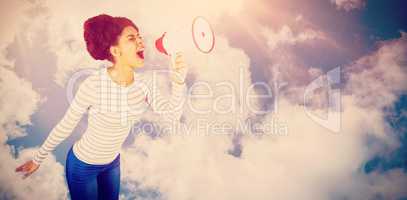 Composite image of carefree young woman yelling with megaphone