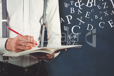 Composite image of mid section of man writing on book