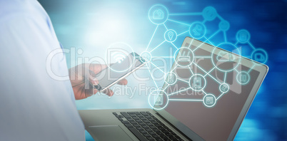 Composite image of businessman using mobile phone and laptop