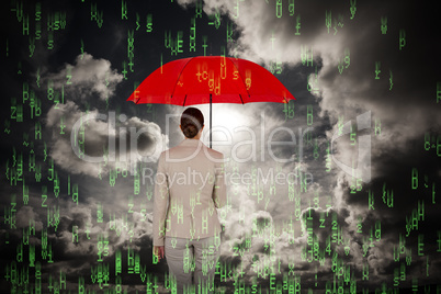 Composite image of rear view of female executive carrying red umbrella