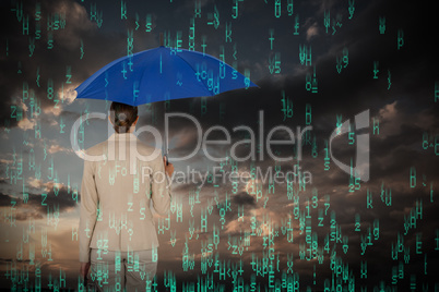 Composite image of rear view of businesswoman carrying blue umbrella