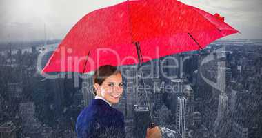 Composite image of portrait of smiling businesswoman holding red umbrella