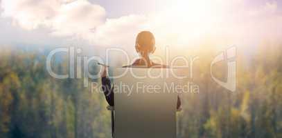 Composite image of rear view of confident businesswoman holding cigar