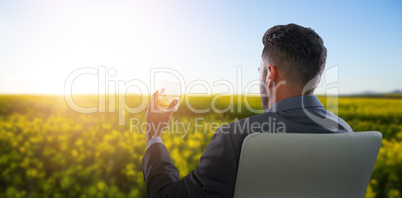 Composite image of rear view of businessman holding whisky glass