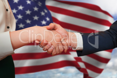 Composite image of corporate partners shaking hands