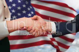 Composite image of corporate partners shaking hands