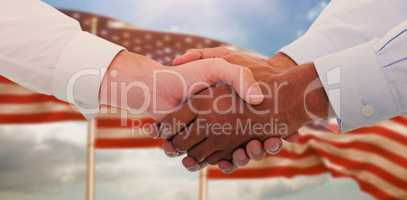 Composite image of close-up shot of a handshake in office