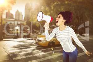 Composite image of carefree young woman yelling with megaphone