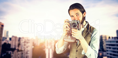 Composite image of portrait of man photographing through vintage camera