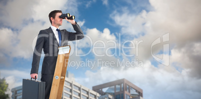 Composite image of businessman looking on a ladder