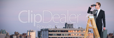 Composite image of businessman looking on a ladder