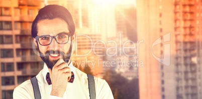 Composite image of portrait of young man smiling with hand on chin