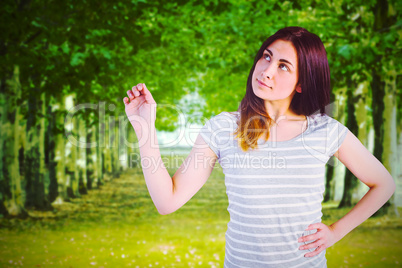 Composite image of thoughtful young woman standing