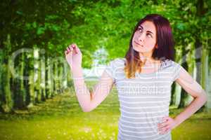 Composite image of thoughtful young woman standing