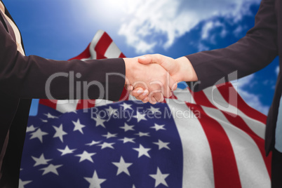 Composite image of businessman shaking hands with colleague