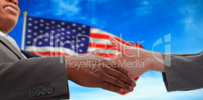 Composite image of businessman going shaking a hand