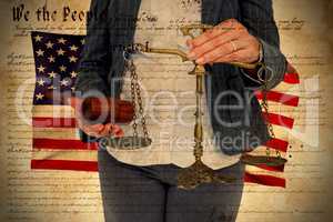 Composite image of female lawyer holding scale and gavel