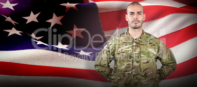 Composite image of portrait of soldier standing with hand behind back