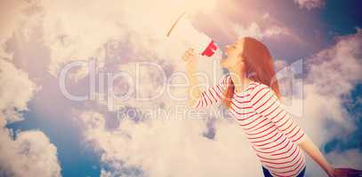 Composite image of carefree young woman making announcement with megaphone
