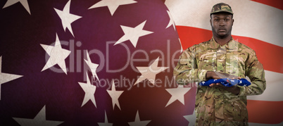 Composite image of portrait of soldier holding american flag