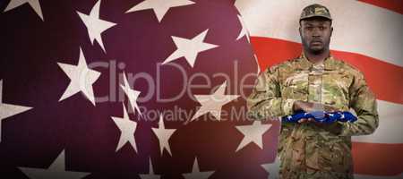 Composite image of portrait of soldier holding american flag