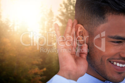 Composite image of close up of smiling businessman trying to listen Composite image of close up of smiling businessman trying to listen