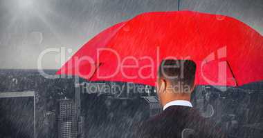 Composite image of rear view of businessman carrying red umbrella