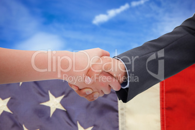 Composite image of close up of a handshake