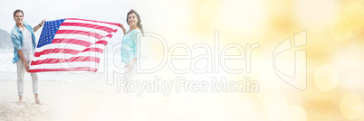 Portrait of couple holding american flag on beach Portrait of couple holding american flag on beach
