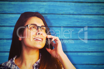 Composite image of close up of young woman talking on phone