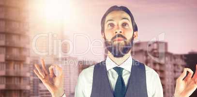Composite image of thoughtful businessman gesturing ok sign
