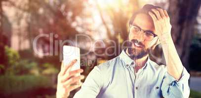 Composite image of man taking selfie with hand in hair