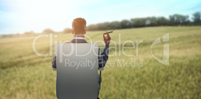 Composite image of rear view of businessman holding cigar