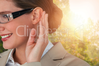 Composite image of close up of smiling businesswoman trying to listen