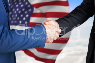 Composite image of male executives shaking hands