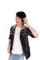Asian teenager talking at his cellphone.