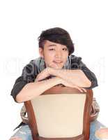 Asian man sitting backwards on chair.