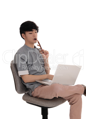 Young man working at laptop.