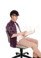 Asian teenager reading book.