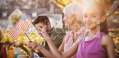 Happy family having a picnic and taking american flag