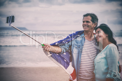 Happy couple with American flag taking selfie