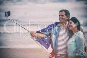 Happy couple with American flag taking selfie