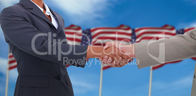 Composite image of side view of hands shaking