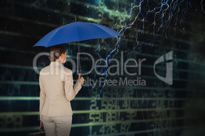 Composite image of businesswoman holding blue umbrella and a briefcase