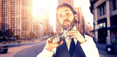 Composite image of portrait of businessman cutting beard through scissors