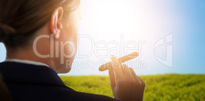 Composite image of businesswoman holding cigar