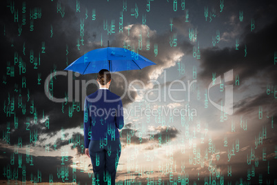 Composite image of rear view of businesswoman holding blue umbrella
